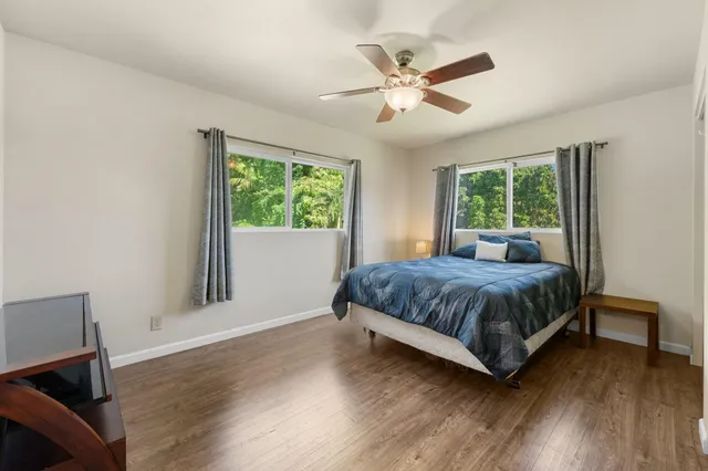 a bedroom with a large bed and a window
