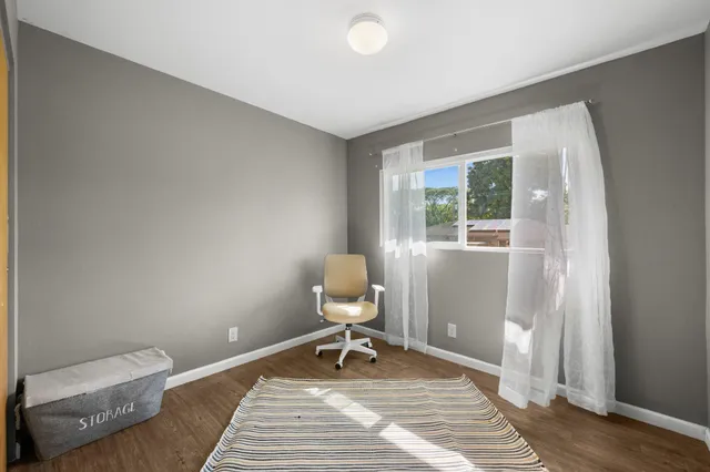 a room with a chair and wooden floor