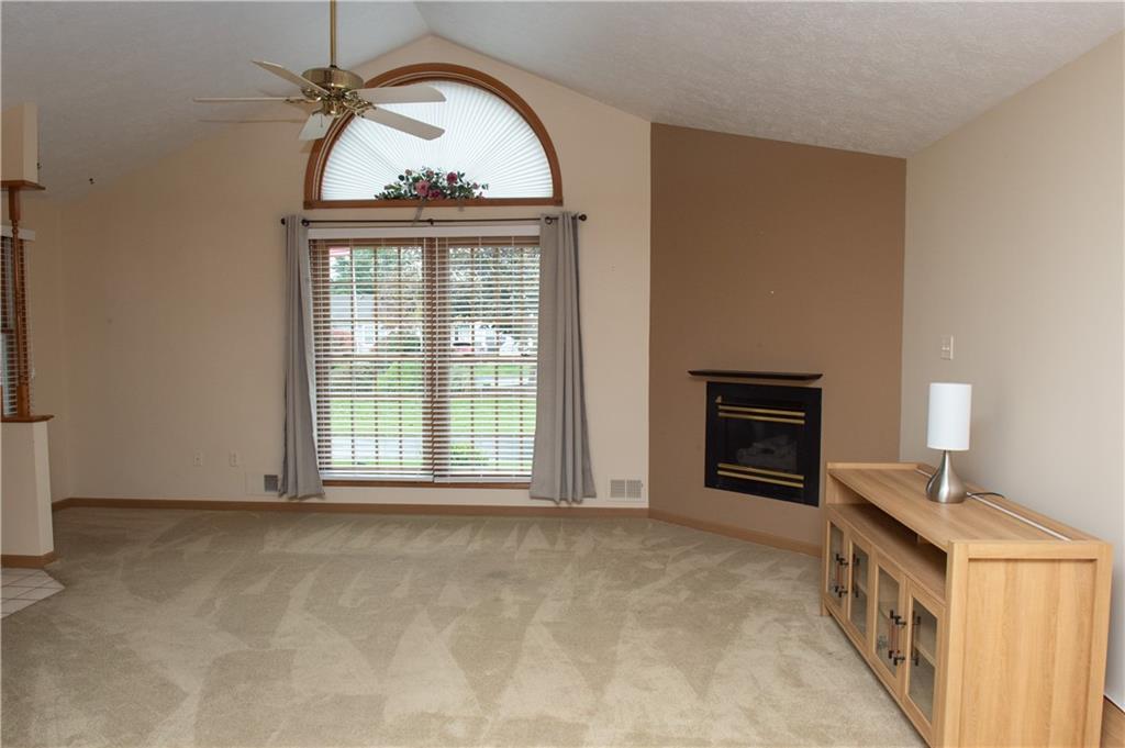 103 Surrey Lane Butler, PA 16001 - Photo 6 of 22 Living Room features gas fireplace and large window to let in abundant natural sunlight.