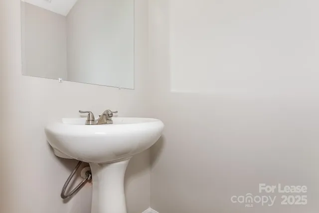 a bathroom with a sink a mirror and a toilet