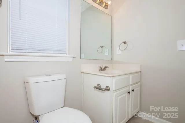 a bathroom with a sink a toilet and mirror