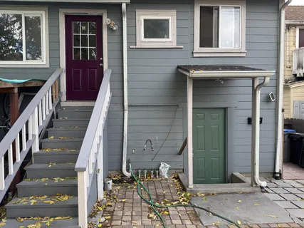 a couple of cars parked in front of a house