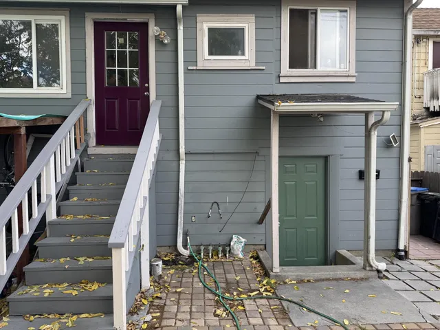 a couple of cars parked in front of a house