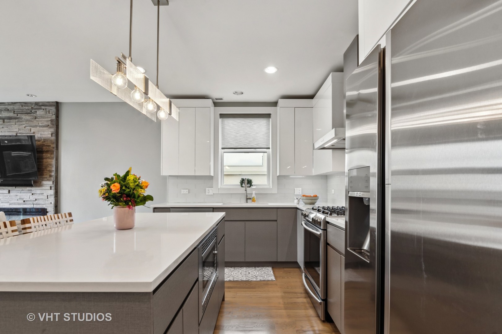 1209 East 46th Street, Unit 4E Chicago, IL 60653 - Photo 7 of 15 a kitchen with a sink stainless steel appliances cabinets and a window