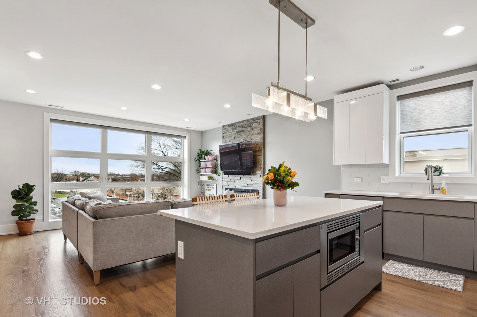 1209 East 46th Street, Unit 4E Chicago, IL 60653 - Photo 8 of 15 a kitchen with a sink stove top oven and living room view