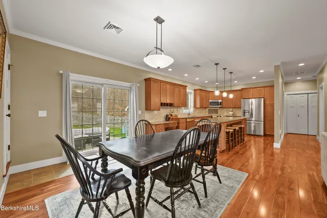 a dining room with furniture window and wooden floor