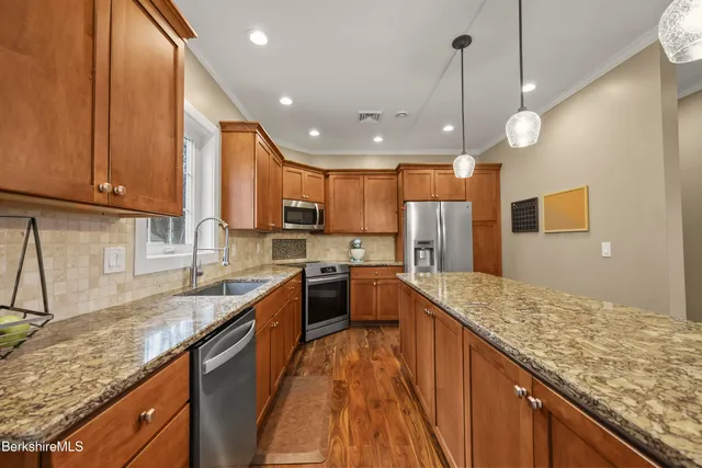 a large kitchen with kitchen island granite countertop a large center island and a sink