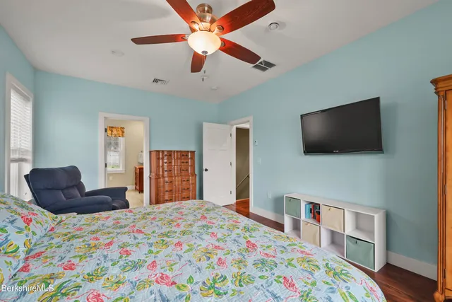 a en suite bathroom with a granite countertop sink and a mirror