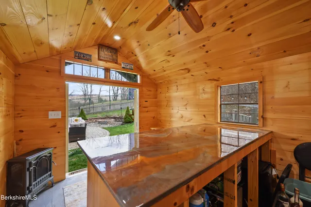 a kitchen with stainless steel appliances kitchen island granite countertop a stove cabinets and wooden floor
