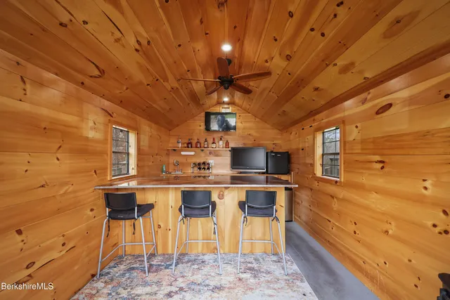 a wooden bench sitting in the middle of a park