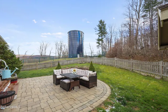 a view of a house with backyard and sitting area