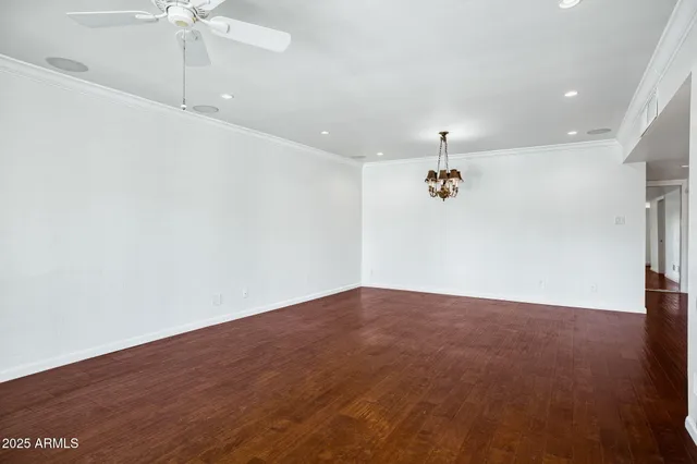 an empty room with fan and windows