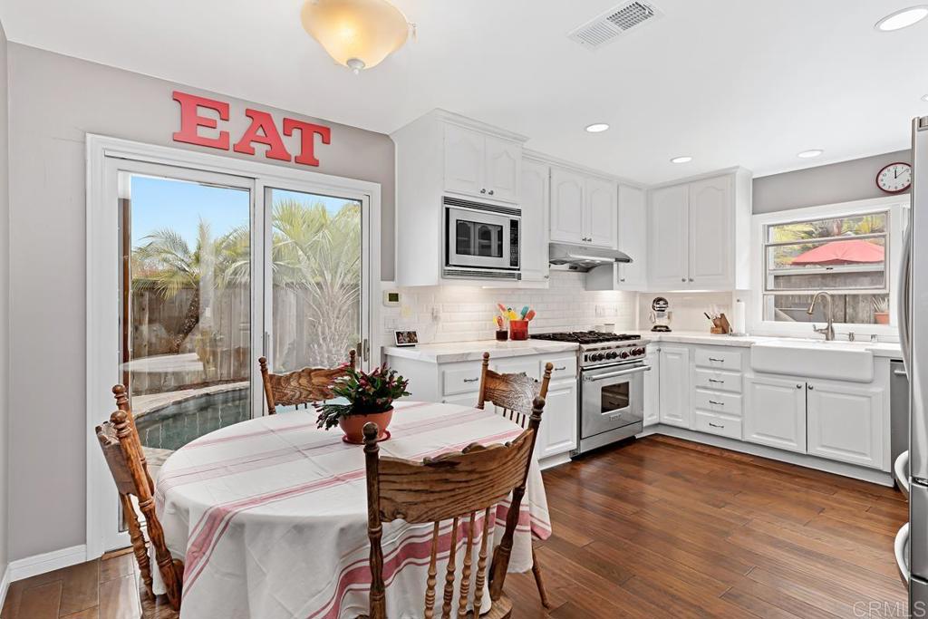1369 Cherrytree Court Encinitas, CA 92024 - Photo 11 of 41 a kitchen that has a table and chairs in it