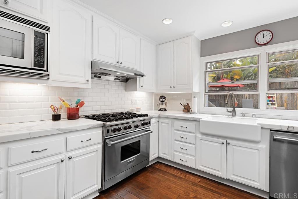 1369 Cherrytree Court Encinitas, CA 92024 - Photo 12 of 41 a kitchen with cabinets appliances and a window