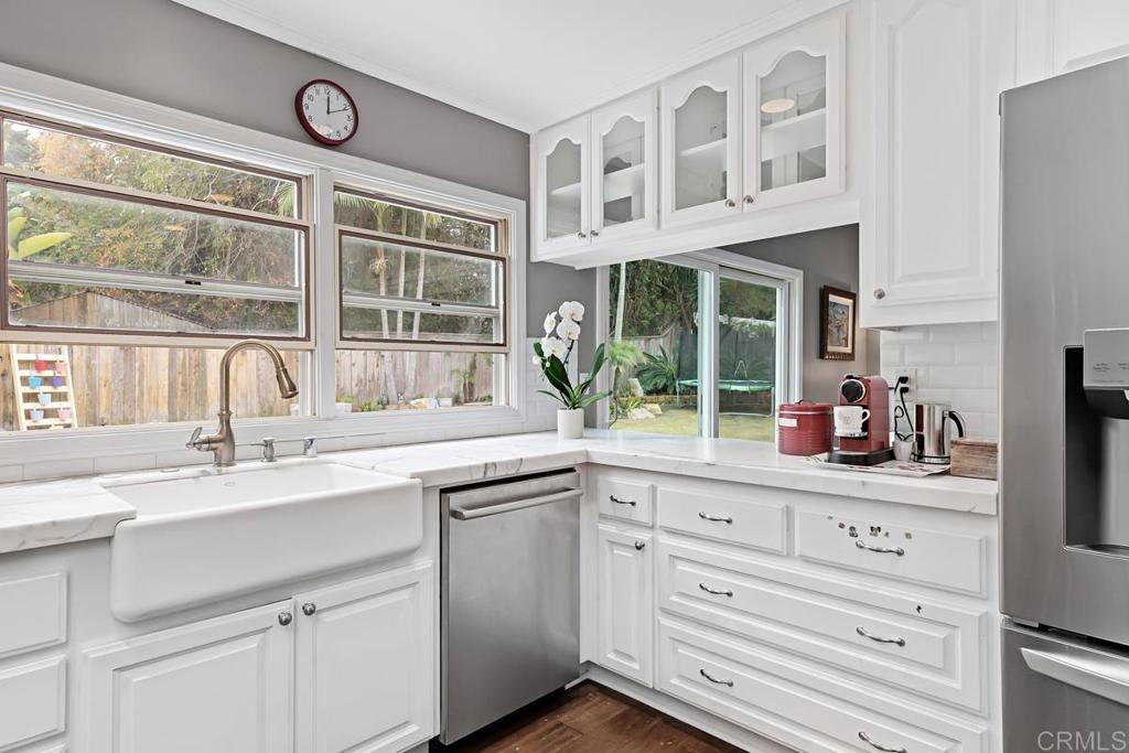 1369 Cherrytree Court Encinitas, CA 92024 - Photo 13 of 41 a kitchen with granite countertop a sink and a window