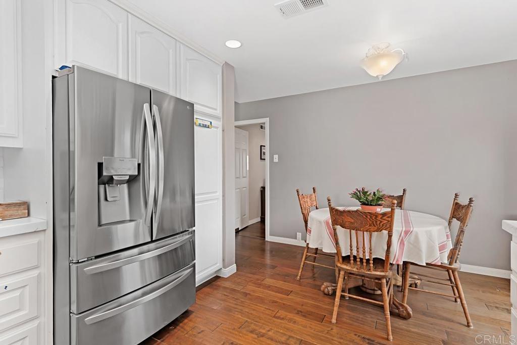 1369 Cherrytree Court Encinitas, CA 92024 - Photo 14 of 41 a kitchen with stainless steel appliances a refrigerator and wooden floor