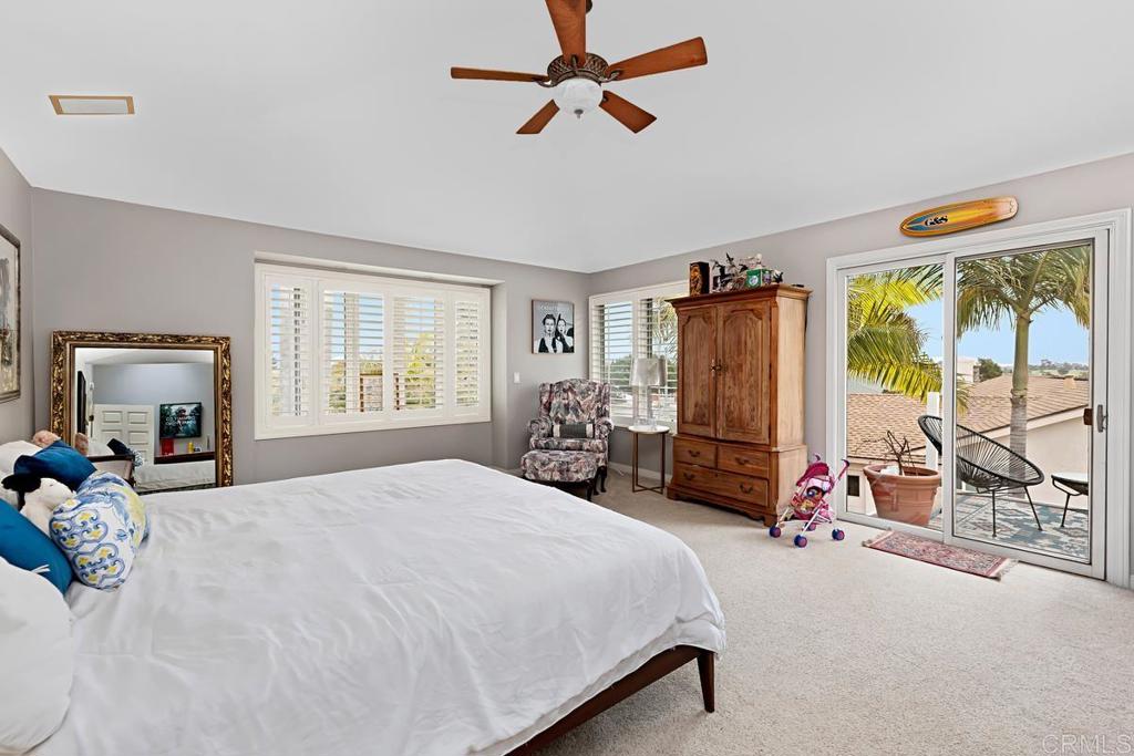 1369 Cherrytree Court Encinitas, CA 92024 - Photo 20 of 41 a bedroom with a bed gym equipment and large window