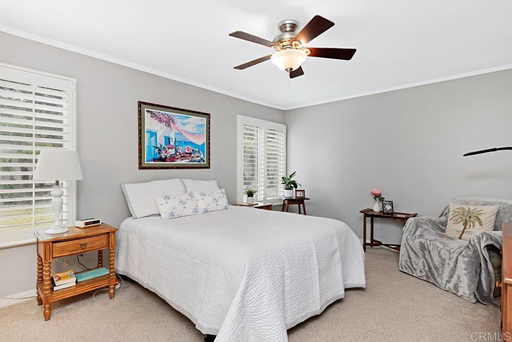 1369 Cherrytree Court Encinitas, CA 92024 - Photo 29 of 41 a bedroom with a bed and a chandelier