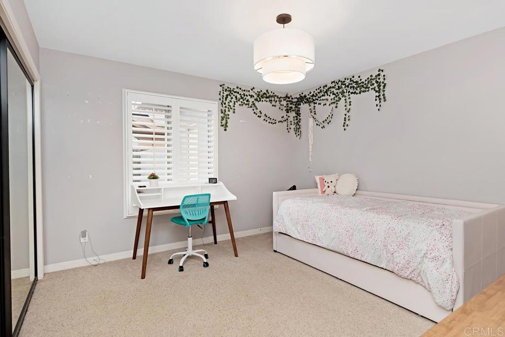 1369 Cherrytree Court Encinitas, CA 92024 - Photo 32 of 41 a bedroom with a bed and a chandelier