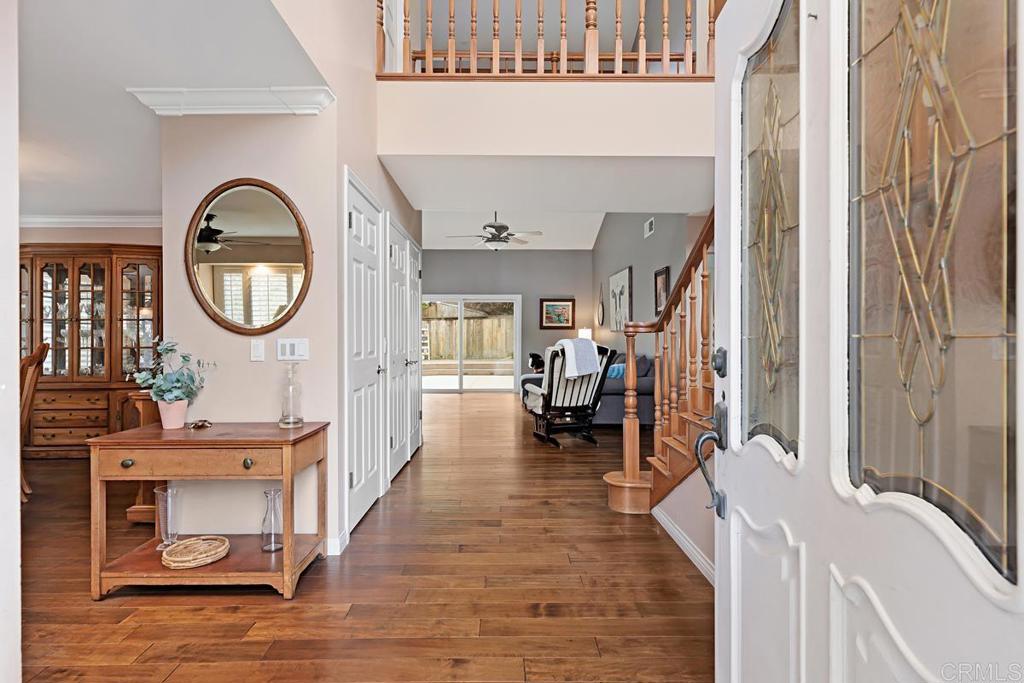 1369 Cherrytree Court Encinitas, CA 92024 - Photo 5 of 41 a living room with furniture a mirror and a wooden floor