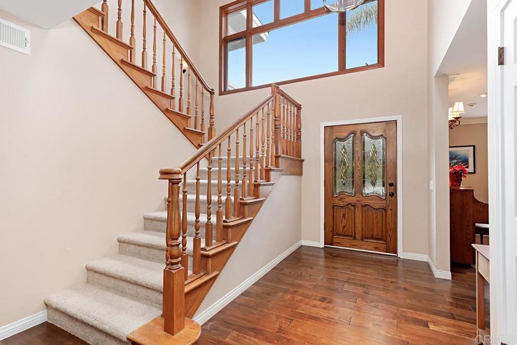 1369 Cherrytree Court Encinitas, CA 92024 - Photo 6 of 41 a view of staircase with lots of frames on wall and a potted plant