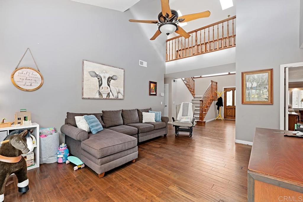 1369 Cherrytree Court Encinitas, CA 92024 - Photo 8 of 41 a living room with furniture a ceiling fan and a wooden floor