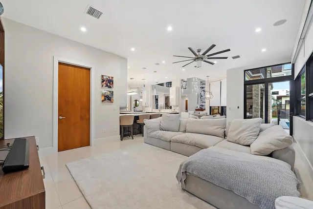 a living room with furniture ceiling fan and a wooden floor
