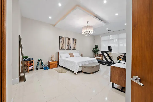 a bedroom with furniture and a chandelier