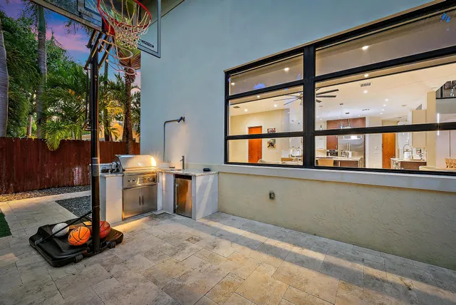 a view of a patio with table and chairs and potted plants