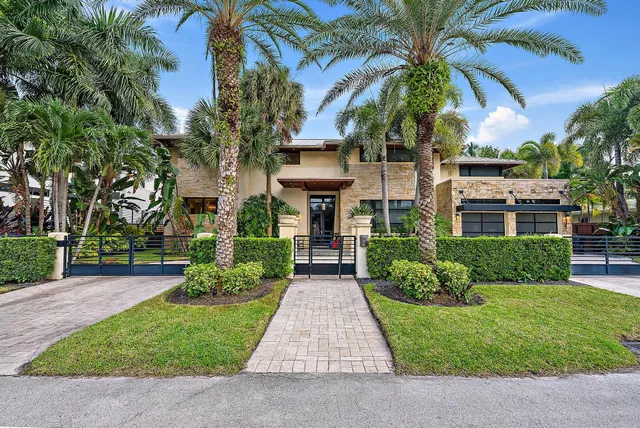 front view of a brick house with a yard