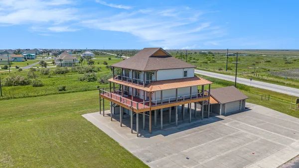 an aerial view of a house with a ocean view