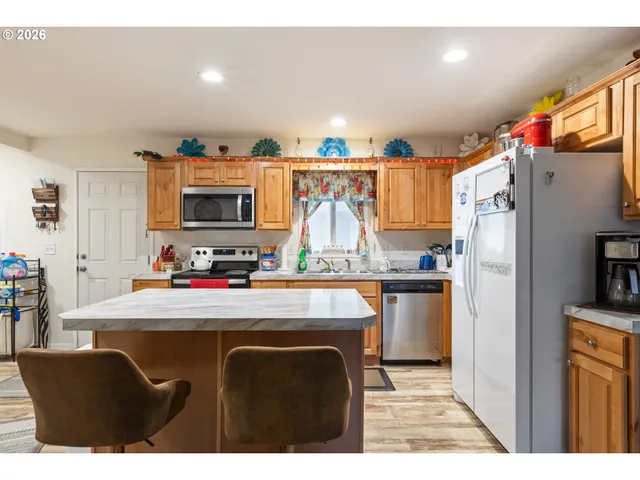 a kitchen with refrigerator and cabinets