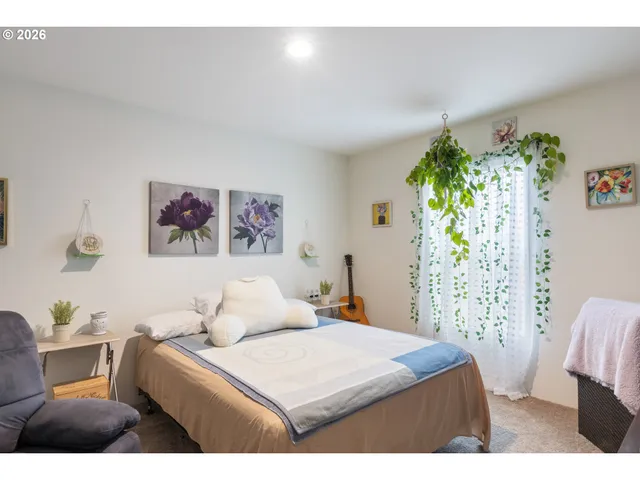 a bedroom with furniture and a flat screen tv