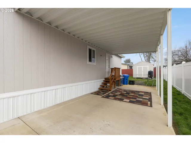 a front view of house with yard and trees in the background
