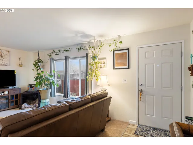 a living room with furniture and large window