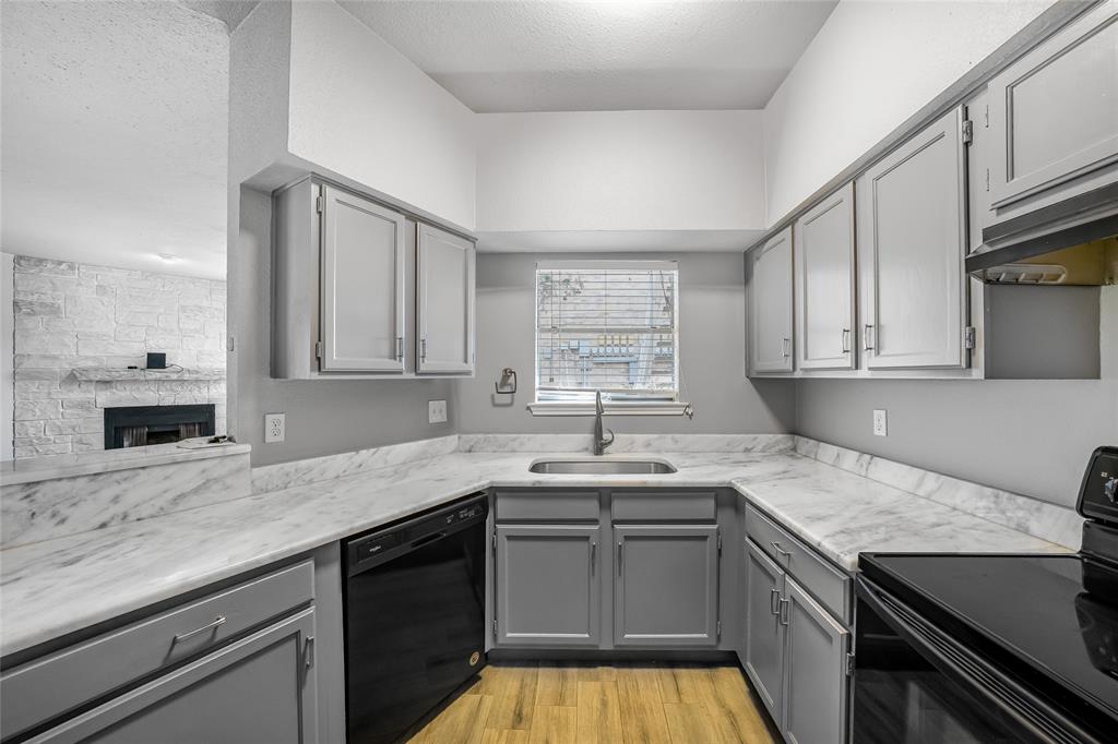 2450 Wickersham Lane, Unit M1301 Austin, TX 78741 - Photo 2 of 11 a kitchen with a sink stove and cabinets