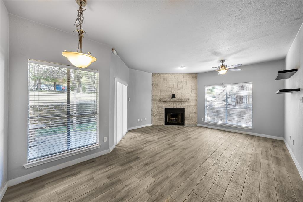 2450 Wickersham Lane, Unit M1301 Austin, TX 78741 - Photo 4 of 11 a view of an empty room with wooden floor and a window
