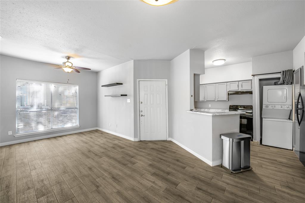 2450 Wickersham Lane, Unit M1301 Austin, TX 78741 - Photo 5 of 11 a view of a kitchen with a sink a refrigerator and wooden floor