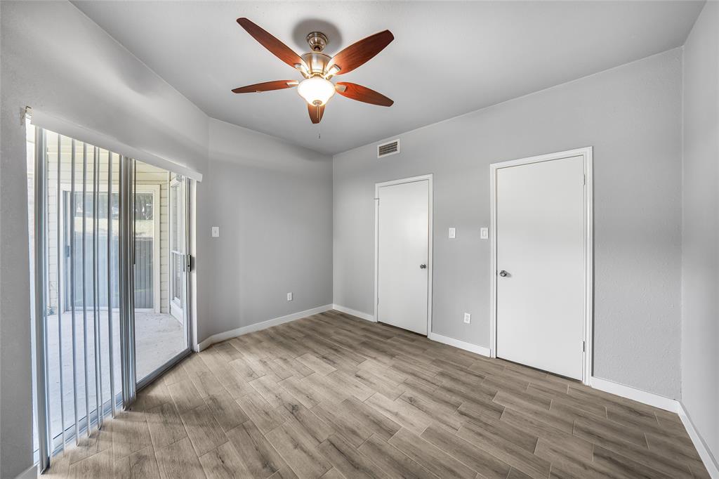 2450 Wickersham Lane, Unit M1301 Austin, TX 78741 - Photo 8 of 11 wooden floor in an empty room with a window