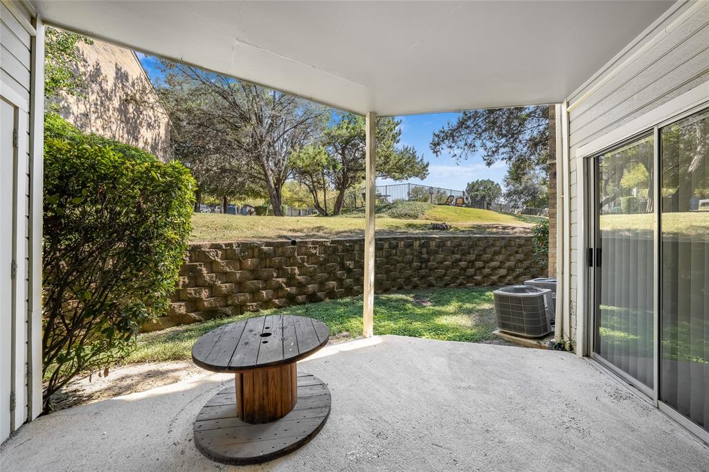 2450 Wickersham Lane, Unit M1301 Austin, TX 78741 - Photo 10 of 11 a view of a porch with furniture and floor to ceiling window