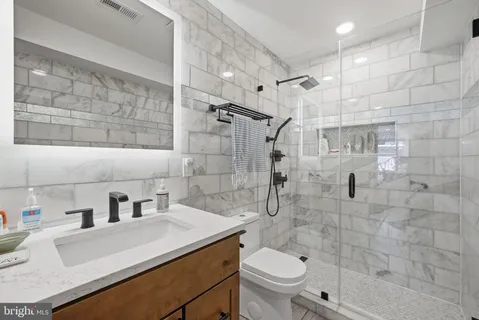 a bathroom with a sink toilet and shower