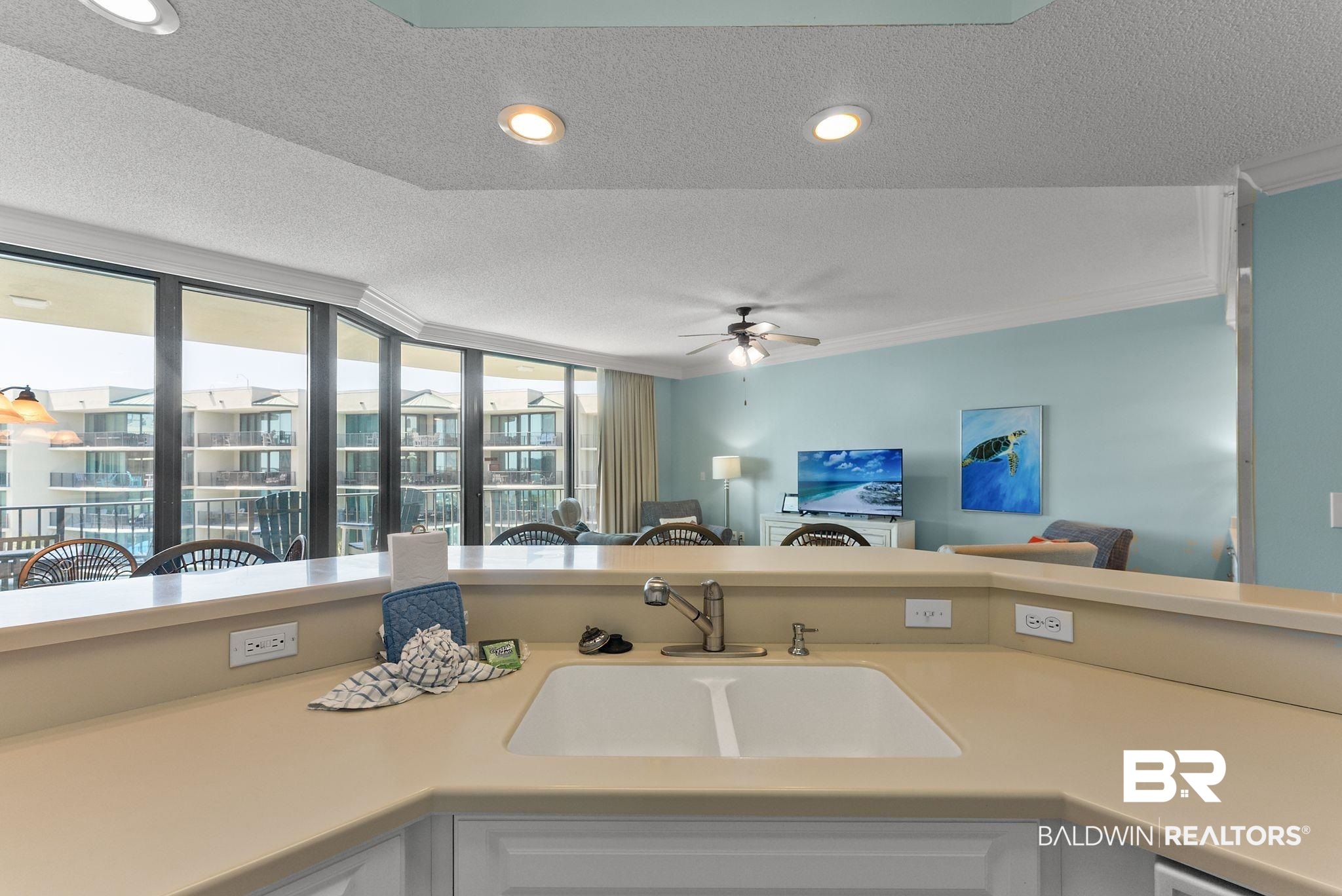 27580 Canal Road, Unit 1427 Orange Beach, AL 36561 - Photo 38 of 38 Kitchen with a textured ceiling, light countertops, open floor plan, white cabinets, and recessed lighting