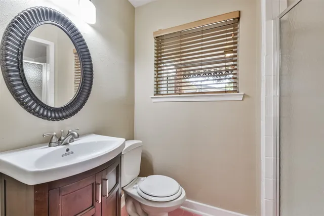 a bathroom with a sink a toilet and a mirror