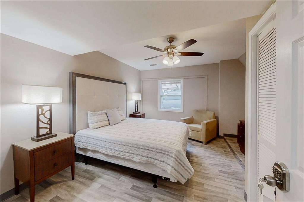 2284 Emerald Springs Drive Decatur, GA 30035 - Photo 25 of 30 a bedroom with a bed and a chandelier