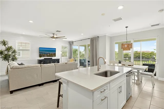 a kitchen with sink refrigerator and living room