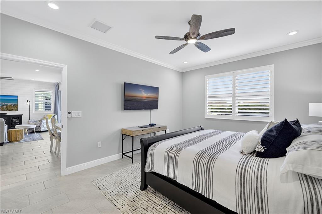 2319 Sawyers Hill Road, Unit 705 Naples, FL 34102 - Photo 14 of 29 Bedroom with ornamental molding, recessed lighting, ceiling fan, and light tile patterned flooring