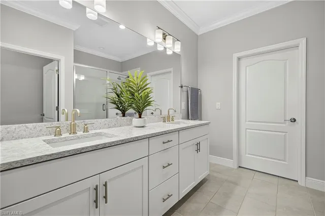 a bathroom with a double vanity sink and a mirror