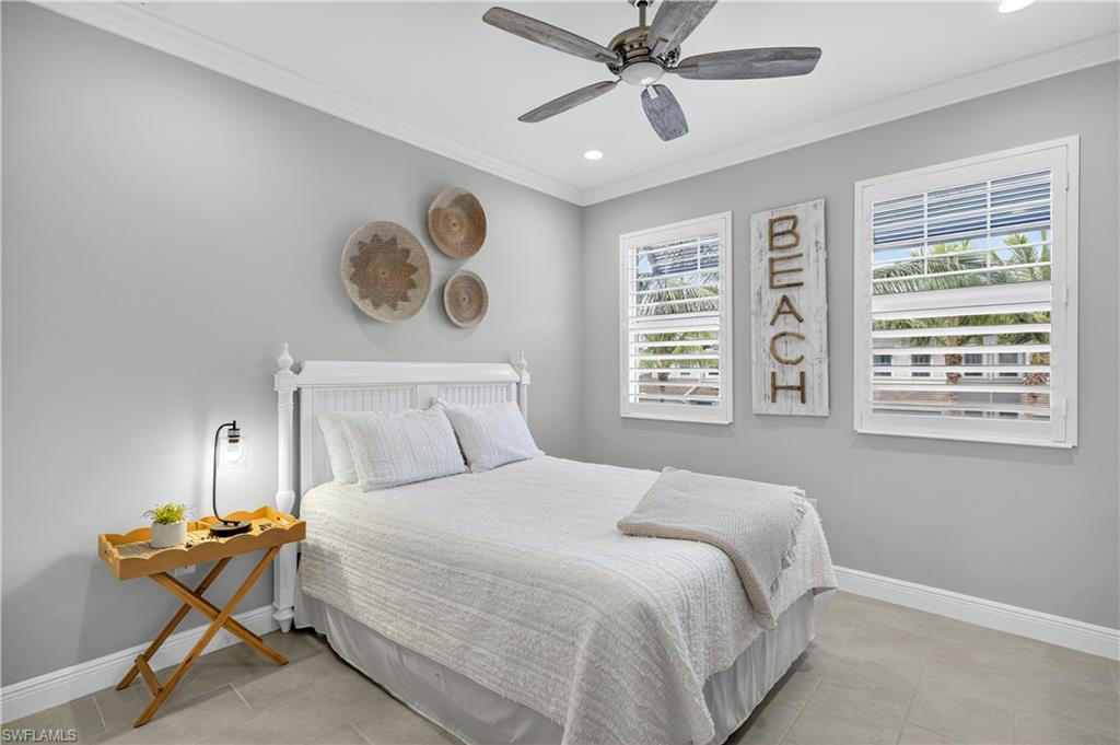 2319 Sawyers Hill Road, Unit 705 Naples, FL 34102 - Photo 18 of 29 Bedroom with ornamental molding, multiple windows, a ceiling fan, light tile patterned floors, and recessed lighting