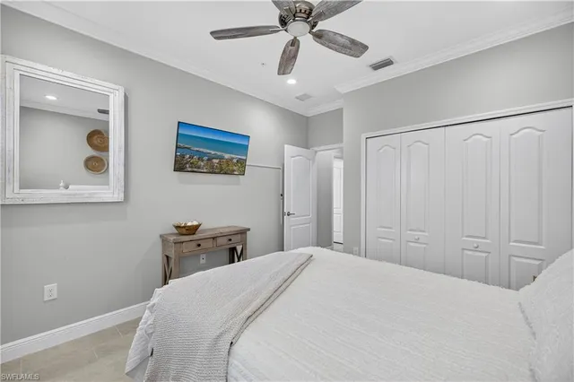 a bedroom with a large bed and a chandelier