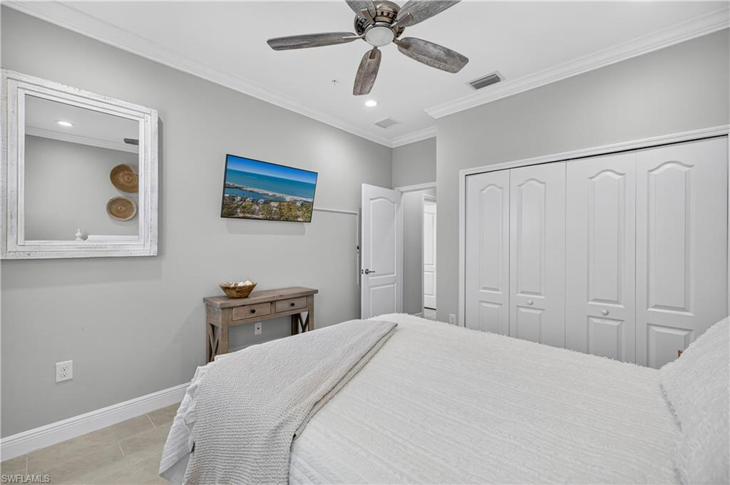 2319 Sawyers Hill Road, Unit 705 Naples, FL 34102 - Photo 19 of 29 Tiled bedroom featuring ornamental molding, a ceiling fan, a closet, and recessed lighting